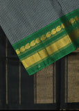 Athena is a traditional Gadwal cotton in cloud grey with pure silk Ganga-Jamuna borders in forest green and black and pure silk plain black. Pure zari only has been used.