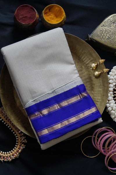 Aphrodite is a traditional Gadwal cotton in plain rice white with silk borders and silk palla in violet. 
