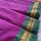 Snigdha is a traditional Gadwal cotton in orchid purple with silk-cotton borders in gren and cotton palla in pink.