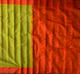 Lasya is a Gadwal cotton-silk in a shot coloured green-yellow with a sunset orange border and an orange silk pallu.  The border and pallu are in pure silk attached to the separately woven cotton body of the saree using the 'kuttu' technique