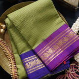 Gaea is a traditional Gadwal cotton in fresh gree with pure silk Ganga-Jamuna borders in purple and violet and a pure silk palla in violet.