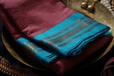 Ahalya is a traditional Gadwal cotton in light red with pure silk borders and pure silk palla in cyan blue.
