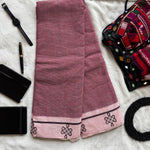 Flatlay of Patteda Anchu cotton saree with black checks and kolam block print