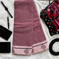 Flatlay of Patteda Anchu cotton saree with black checks and kolam block print