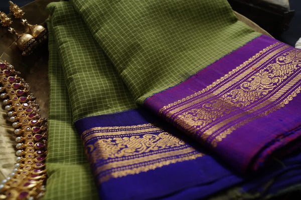 Gaea is a traditional Gadwal cotton in fresh gree with pure silk Ganga-Jamuna borders in purple and violet and a pure silk palla in violet.