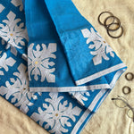 Arohini Greek cyan blue saree with white appliqué