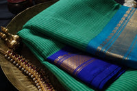 Artemis is a sea-green Gadwal cotton with pure silk Ganga-Jamuna borders in MS Blue and cyan and pure silk palla in MS Blue.