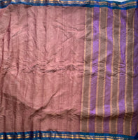 Ahalya is a traditional Gadwal cotton in a rosy brown with silk-cotton borders in cyan blue and simple cotton palla. 