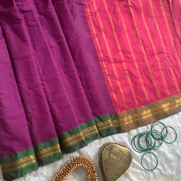 Snigdha is a traditional Gadwal cotton in orchid purple with silk-cotton borders in gren and cotton palla in pink. 