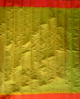 Lasya is a Gadwal cotton-silk in a shot coloured green-yellow with a sunset orange border and an orange silk pallu.  The border and pallu are in pure silk attached to the separately woven cotton body of the saree using the 'kuttu' technique
